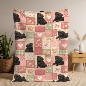 May include: A patchwork quilt-style blanket featuring a repeating pattern of black pugs on a pink, red, and green background. The design includes hearts, flowers, and bows.