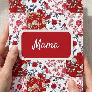 May include: A red and white floral patterned journal with the word "Mama" in white script on a red rectangular label. The journal has a patchwork design with red and white roses.
