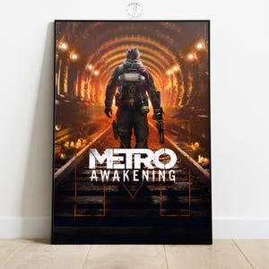 May include: Framed poster featuring a figure walking away from the viewer down a tunnel with train tracks. The poster has the words "METRO AWAKENING" in white block letters. The background is a warm, orange-toned tunnel with lights.
