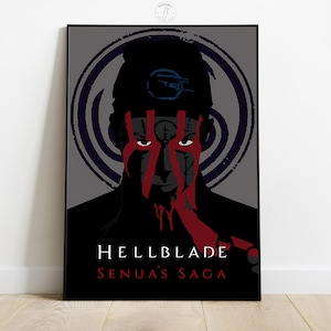 May include: A framed poster featuring a stylized portrait from the video game Hellblade: Senua's Saga. The image shows a person with red war paint and the game's title in white text. A dark spiral design is in the background.