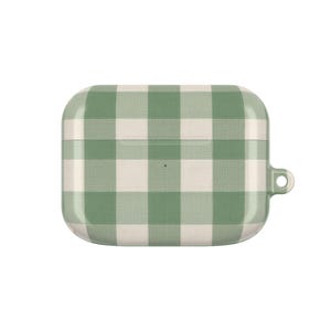 May include: A green and white gingham patterned case for wireless earbuds. The case is rectangular with rounded edges and a small loop on the side. The case is designed to protect and carry earbuds.