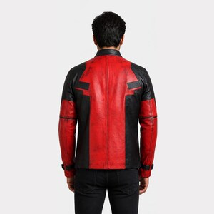 K&ouml;nnte beinhalten: Rote und schwarze Lederjacke mit Used-Look. Die Jacke hat einen Stehkragen, schwarze Eins&auml;tze an Schultern und &Auml;rmeln sowie eine rote Mittelbahn auf dem R&uuml;cken. Die Jacke hat einen klassischen Biker-Stil.
