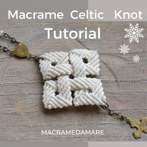 May include: A white macrame Celtic knot with a gold chain and cross pendant. The knot is in the shape of a four-leaf clover. The text "Macrame Celtic Knot Tutorial" and "Macramedamare" are visible in the image.