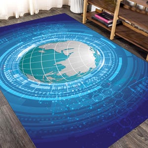 May include: A blue and white area rug featuring a stylized globe at the center, surrounded by concentric circles and digital-style graphics. The rug has a dark blue border and a light blue and white globe design.