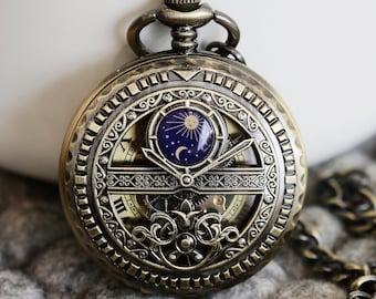 May include: A bronze pocket watch with a skeletonized face and a chain. The watch face features a sun and moon design with a blue background.
