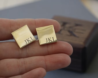 May include: Two gold-colored cufflinks with the initials "JKL" engraved on each.