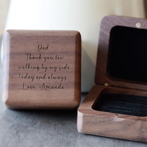 May include: A wooden ring box with a hinged lid. The lid is engraved with the message "Dad. Thank you for walking by my side today and always. Love. Amanda."