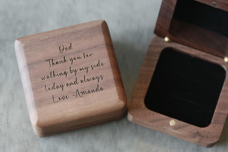 May include: A wooden box with a hinged lid. The lid is engraved with the message "Dad. Thank you for walking by my side today and always. Love. Amanda".