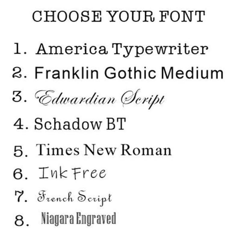 May include: A list of eight different font styles to choose from for a personalized item. The font styles are: America Typewriter, Franklin Gothic Medium, Edwardian Script, Schadow BT, Times New Roman, Ink Free, French Script, and Niagara Engraved.