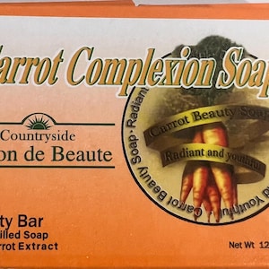 May include: Orange box of "Carrot Complexion Soap" with text and a carrot illustration. The box reads "Countryside Savon de Beaute" and "Beauty Bar Quad-Milled Soap with Carrot Extract". Net weight is 4.4 oz.