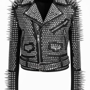 May include: Black leather jacket with silver studs and spikes. The jacket features a classic biker style with a notched collar, asymmetrical zipper closure, and multiple pockets. The shoulders and sleeves are adorned with long, pointed spikes.
