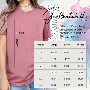 May include: A dusty rose t-shirt with a size chart in centimeters. The chart includes measurements for length, width, and sleeve length for sizes XS to XXL. The text on the chart advises to measure the exact size before ordering to ensure a good fit.
