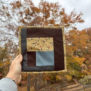 May include: A rustic wooden sign with the text "Welcome to our home" in white lettering. The sign features a distressed finish and a simple, inviting design, perfect for front door decor.