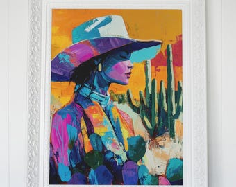 May include: A framed art print featuring a colorful portrait of a person wearing a cowboy hat. The artwork uses vibrant hues of blue, purple, pink, and yellow, depicting a desert landscape with cacti.