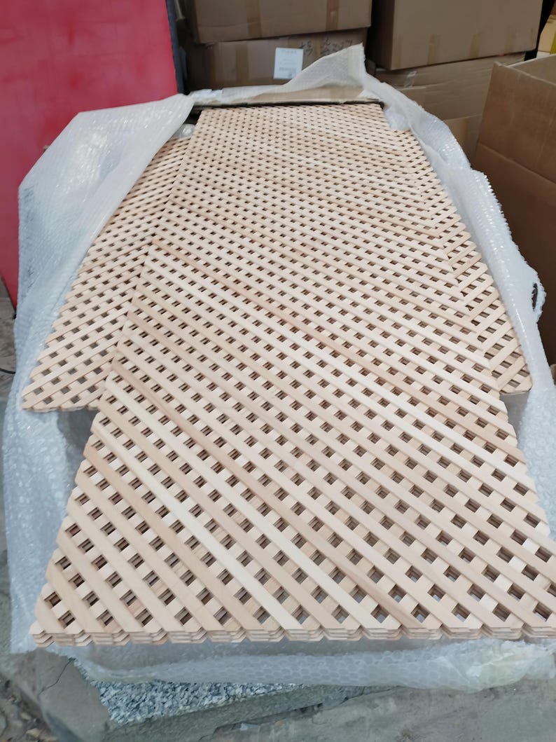 a wooden lattice with a grid pattern, wrapped in bubble wrap and placed on a surface.