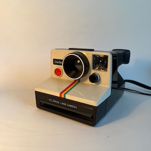 Vintage Polaroid One-Step SX-70 with 7 pictures loaded
