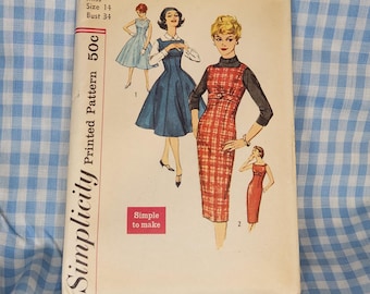 May include: Vintage Simplicity sewing pattern featuring illustrations of dresses. The pattern cover displays the number 2651, size 14, and bust 34. The cover also includes the text "Simple to make" and "Printed Pattern 50c".