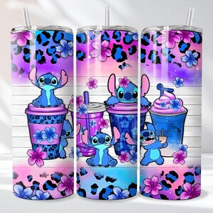 May include: Three tall, insulated tumblers with a colorful design featuring the character Stitch. The design includes blue and purple leopard print, flowers, and Stitch illustrations with beverages. Each tumbler has a straw.