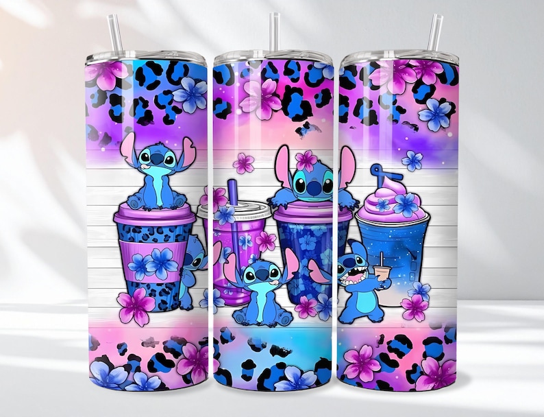 May include: Three tall, insulated tumblers with a colorful design featuring the character Stitch. The design includes blue and purple leopard print, flowers, and Stitch illustrations with beverages. Each tumbler has a straw.