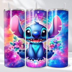 May include: A set of three stainless steel tumblers featuring a vibrant cartoon character design. The character is blue with large ears, a wide smile, and is surrounded by colorful flowers and a galaxy-themed background. Each tumbler has a straw.