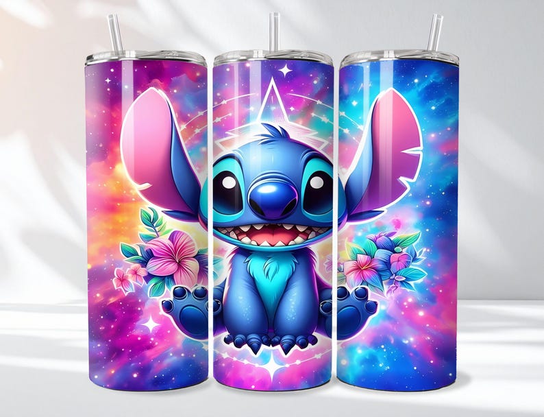 May include: A set of three stainless steel tumblers featuring a vibrant cartoon character design. The character is blue with large ears, a wide smile, and is surrounded by colorful flowers and a galaxy-themed background. Each tumbler has a straw.