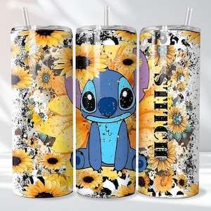 May include: A tumbler featuring a blue cartoon character with large eyes, surrounded by yellow sunflowers. The design includes the word "Stitch" in black vertical text, set against a white and black speckled background. A straw is visible.