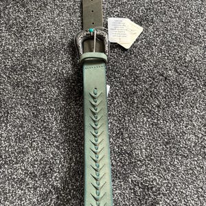 May include: A distressed green leather belt with a decorative silver buckle and turquoise accent. The belt features a series of cut-out designs along its length. A tag is attached to the belt.