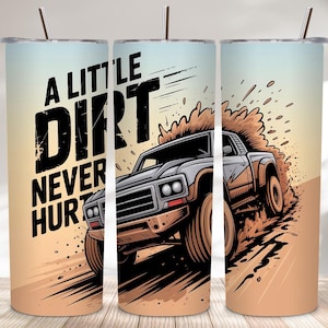 May include: A tumbler with a design featuring a truck kicking up dirt. The text "A Little Dirt Never Hurt" is displayed in bold, black letters. The background has a gradient of light blue and tan.