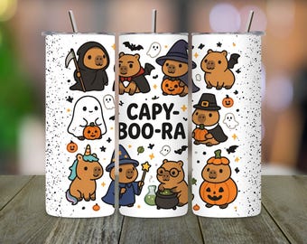 May include: White tumbler featuring Halloween-themed capybaras in various costumes, including a grim reaper, vampire, and witch. The tumbler has a black speckled design and the text "CAPY-BOO-RA".