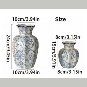 May include: Two ceramic vases with a blue and white floral pattern and scalloped rims. The larger vase measures 9.45 inches in height and 3.94 inches in width. The smaller vase measures 5.91 inches in height and 3.15 inches in width.