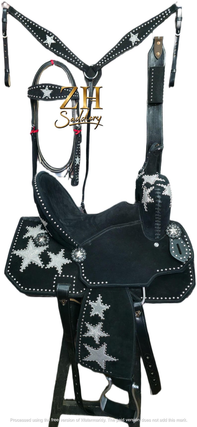May include: Black western saddle set with silver star detailing. The set includes a saddle, bridle, breast collar, and matching accessories. The saddle features silver star conchos and decorative stitching, ideal for equestrian use.