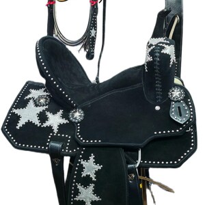 May include: Black western saddle with silver star accents and studded detailing. Includes a matching headstall, breast collar, and other accessories. The saddle is designed for horseback riding.