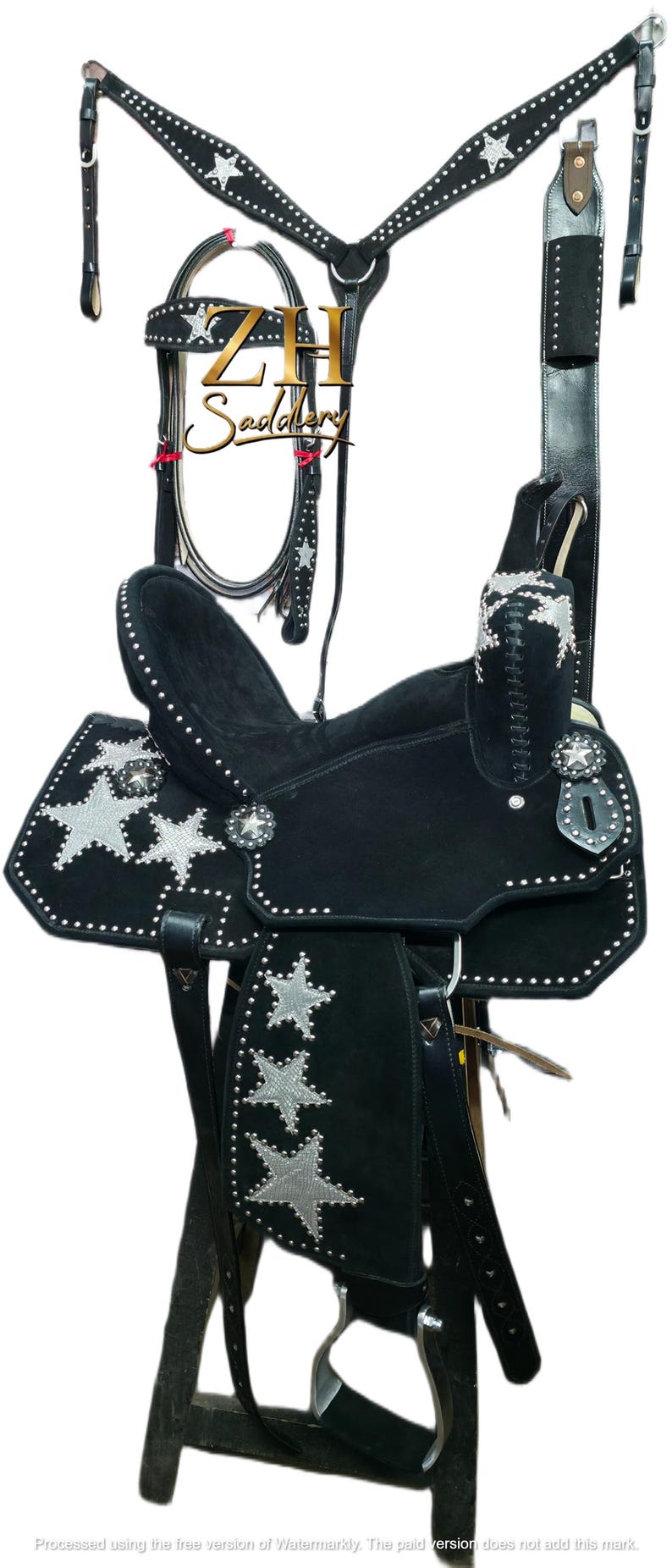 May include: Black western saddle with silver star accents and studded detailing. Includes a matching headstall, breast collar, and other accessories. The saddle is designed for horseback riding.