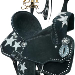 May include: Black western saddle with silver star detailing and studded trim. Includes a matching bridle and reins. The saddle has a suede seat and decorative silver conchos. The brand name "ZH Saddlery" is visible.