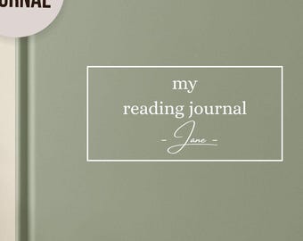 May include: A sage green reading journal with the text "my reading journal - Jane" in a white rectangular frame. The journal has a minimalist design. A circular sticker says "Custom Journal". Another sticker says "Ships Fast".