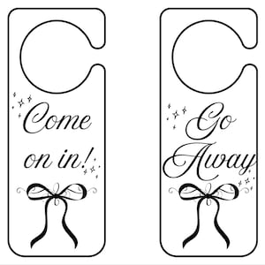 May include: Two white door hangers with black text and bow designs. One reads "Come on in!" and the other "Go Away". Both have a curved top for hanging and star accents.