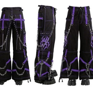 May include: Black pants with purple accents, featuring multiple pockets, decorative chains, and straps. The pants have a unique design with a gothic or punk aesthetic, suitable for alternative fashion.