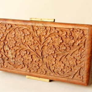 Wood Dresser Box Hand Carved Mahogany Box Lined Vintage 1960s.
Rich Hand-Carved Mahogany Dresser Box Featuring Brass Handles and Green Fabric Lining. 
The Lining is Very Old and Thin.
Wood Box Measures 6 7/8 Inches By 4 Inches By 1 1/2 Inches Tall.