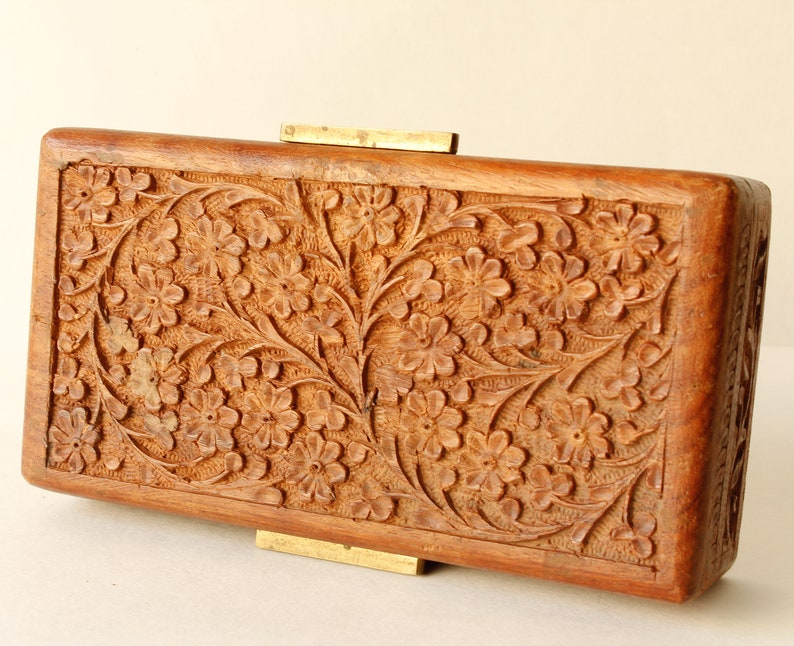 Wood Dresser Box Hand Carved Mahogany Box Lined Vintage 1960s.
Rich Hand-Carved Mahogany Dresser Box Featuring Brass Handles and Green Fabric Lining. 
The Lining is Very Old and Thin.
Wood Box Measures 6 7/8 Inches By 4 Inches By 1 1/2 Inches Tall.