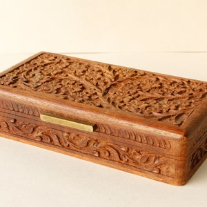 Wood Dresser Box Hand Carved Mahogany Box Lined Vintage 1960s.
Rich Hand-Carved Mahogany Dresser Box Featuring Brass Handles and Green Fabric Lining. 
The Lining is Very Old and Thin.
Wood Box Measures 6 7/8 Inches By 4 Inches By 1 1/2 Inches Tall.