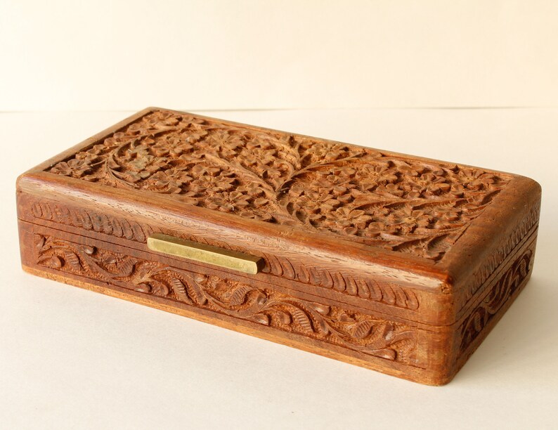 Wood Dresser Box Hand Carved Mahogany Box Lined Vintage 1960s.
Rich Hand-Carved Mahogany Dresser Box Featuring Brass Handles and Green Fabric Lining. 
The Lining is Very Old and Thin.
Wood Box Measures 6 7/8 Inches By 4 Inches By 1 1/2 Inches Tall.