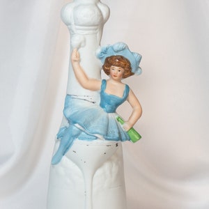 Vintage Porcelain Flask Figural Girl Sitting in Glass Empty Decanter