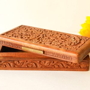 Wood Dresser Box Hand Carved Mahogany Box Lined Vintage 1960s.
Rich Hand-Carved Mahogany Dresser Box Featuring Brass Handles and Green Fabric Lining. 
The Lining is Very Old and Thin.
Wood Box Measures 6 7/8 Inches By 4 Inches By 1 1/2 Inches Tall.