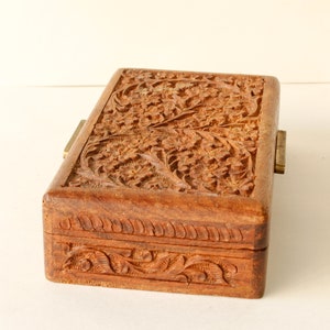 Wood Dresser Box Hand Carved Mahogany Box Lined Vintage 1960s.
Rich Hand-Carved Mahogany Dresser Box Featuring Brass Handles and Green Fabric Lining. 
The Lining is Very Old and Thin.
Wood Box Measures 6 7/8 Inches By 4 Inches By 1 1/2 Inches Tall.