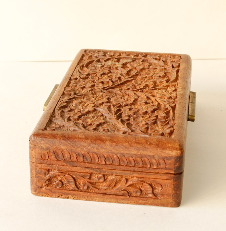 Wood Dresser Box Hand Carved Mahogany Box Lined Vintage 1960s.
Rich Hand-Carved Mahogany Dresser Box Featuring Brass Handles and Green Fabric Lining. 
The Lining is Very Old and Thin.
Wood Box Measures 6 7/8 Inches By 4 Inches By 1 1/2 Inches Tall.