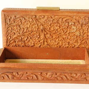 Wood Dresser Box Hand Carved Mahogany Box Lined Vintage 1960s.
Rich Hand-Carved Mahogany Dresser Box Featuring Brass Handles and Green Fabric Lining. 
The Lining is Very Old and Thin.
Wood Box Measures 6 7/8 Inches By 4 Inches By 1 1/2 Inches Tall.