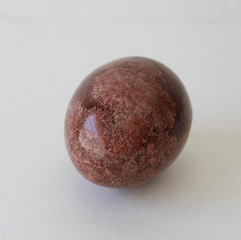 Vintage Brown Marble Stone Egg And Stand With Mirror.
Brown Marble Egg and Lucite Stand and 4-Inch Octagon Mirror. 
The Egg Has a Smooth, High Polish Finish.
The Stand is Clear Lucite.
Egg and Stand Measure 4 Inches.
The Gemstone Egg is 2 3/4 Inches by 2 Inches.
One More Really Nice Egg For your Collection.