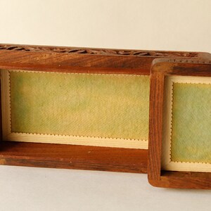 Wood Dresser Box Hand Carved Mahogany Box Lined Vintage 1960s.
Rich Hand-Carved Mahogany Dresser Box Featuring Brass Handles and Green Fabric Lining. 
The Lining is Very Old and Thin.
Wood Box Measures 6 7/8 Inches By 4 Inches By 1 1/2 Inches Tall.