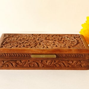 Wood Dresser Box Hand Carved Mahogany Box Lined Vintage 1960s.
Rich Hand-Carved Mahogany Dresser Box Featuring Brass Handles and Green Fabric Lining. 
The Lining is Very Old and Thin.
Wood Box Measures 6 7/8 Inches By 4 Inches By 1 1/2 Inches Tall.
