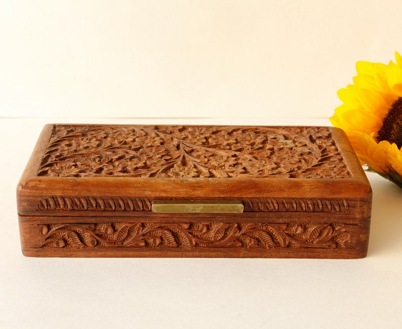 Wood Dresser Box Hand Carved Mahogany Box Lined Vintage 1960s.
Rich Hand-Carved Mahogany Dresser Box Featuring Brass Handles and Green Fabric Lining. 
The Lining is Very Old and Thin.
Wood Box Measures 6 7/8 Inches By 4 Inches By 1 1/2 Inches Tall.